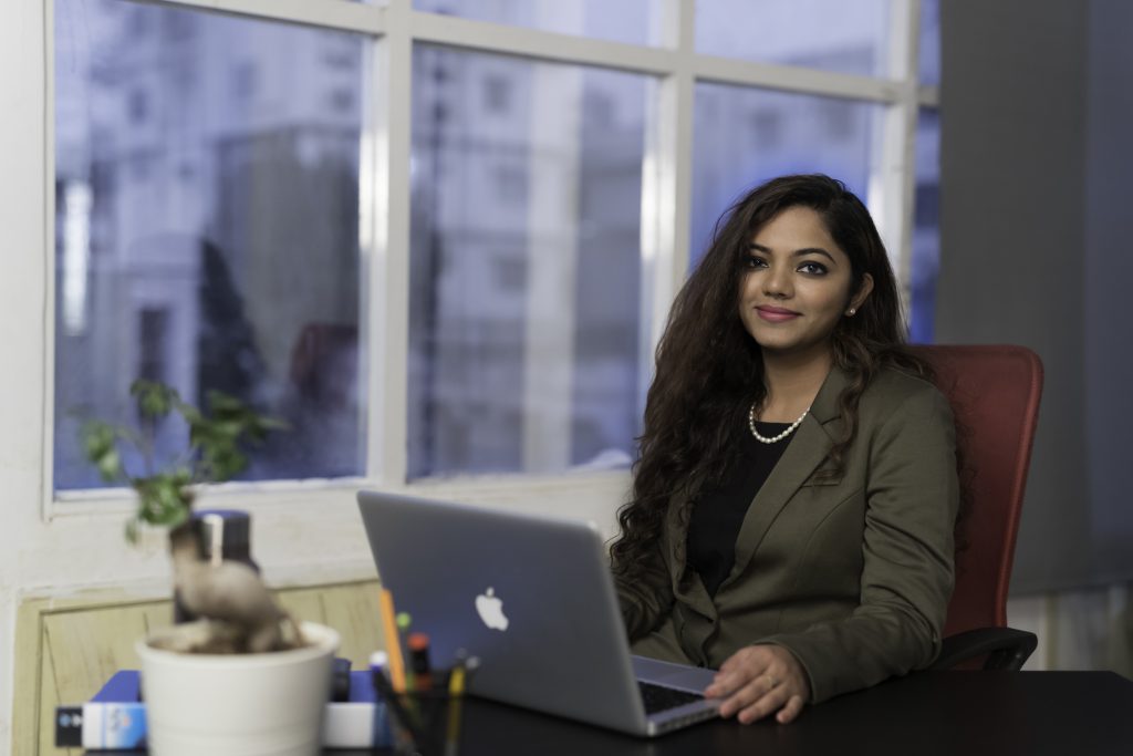 woman sitting at a desk with laptop