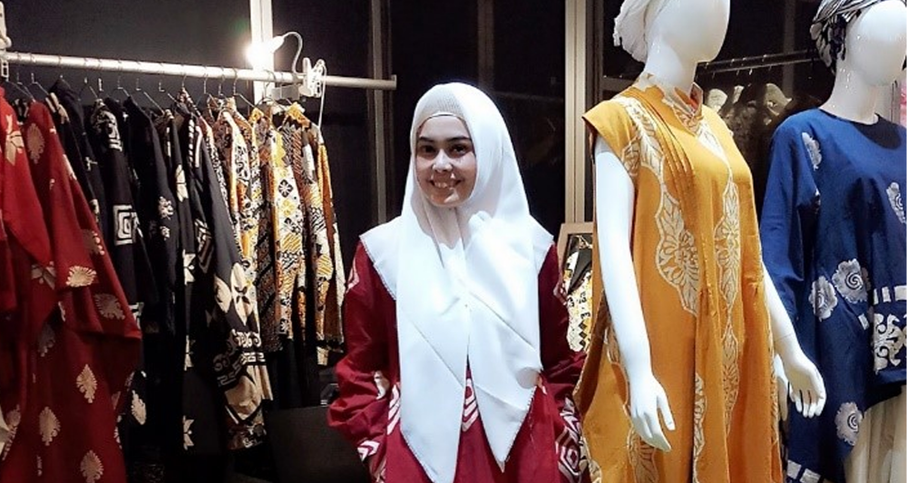 woman smiling in a clothing store